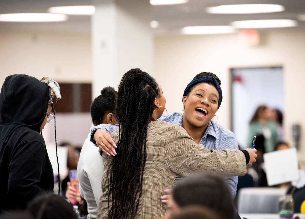 Girls of Color Summit previous event with two girls smiling and hugging